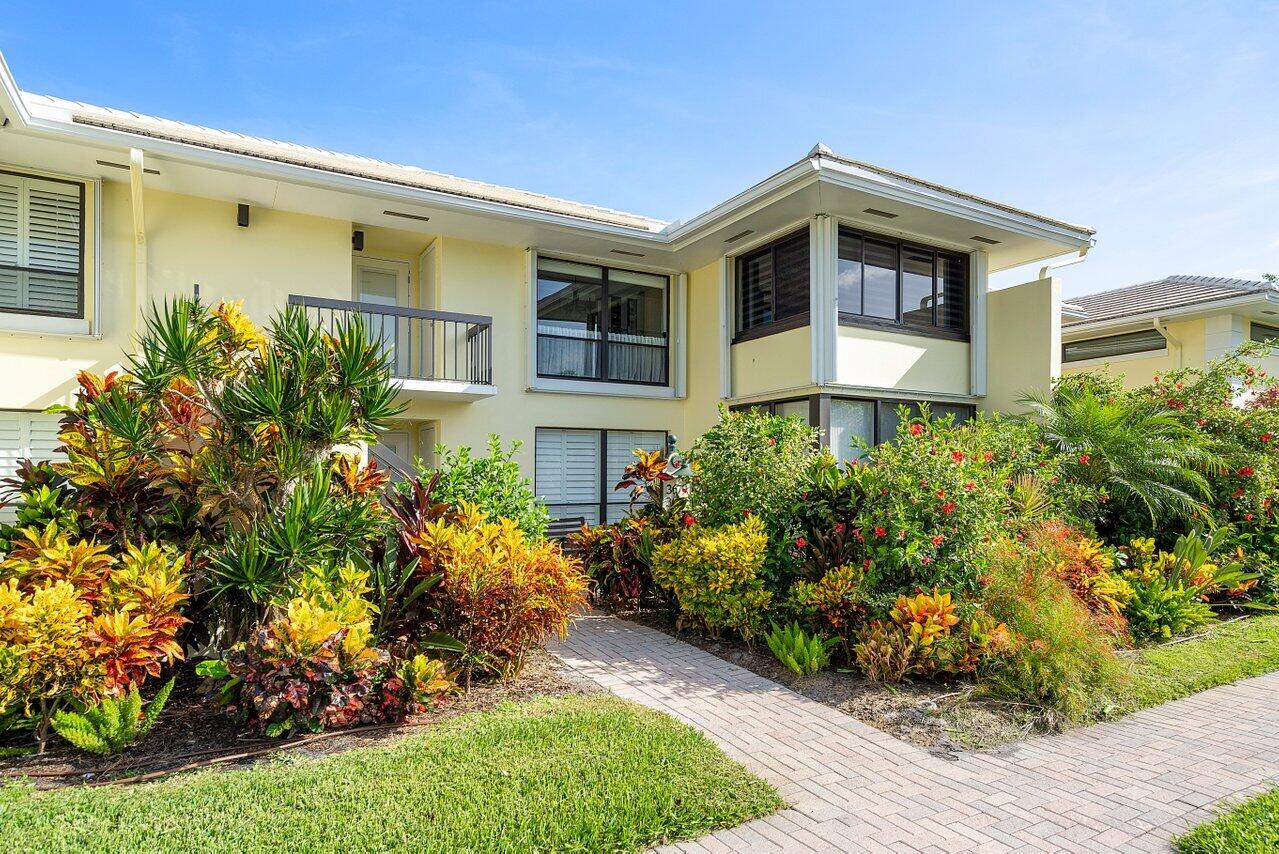 3677 Quail Ridge Drive, Unit BOBWHITE B Boynton Beach, FL 33436 - Photo 36 of 47 a front view of a house with a yard
