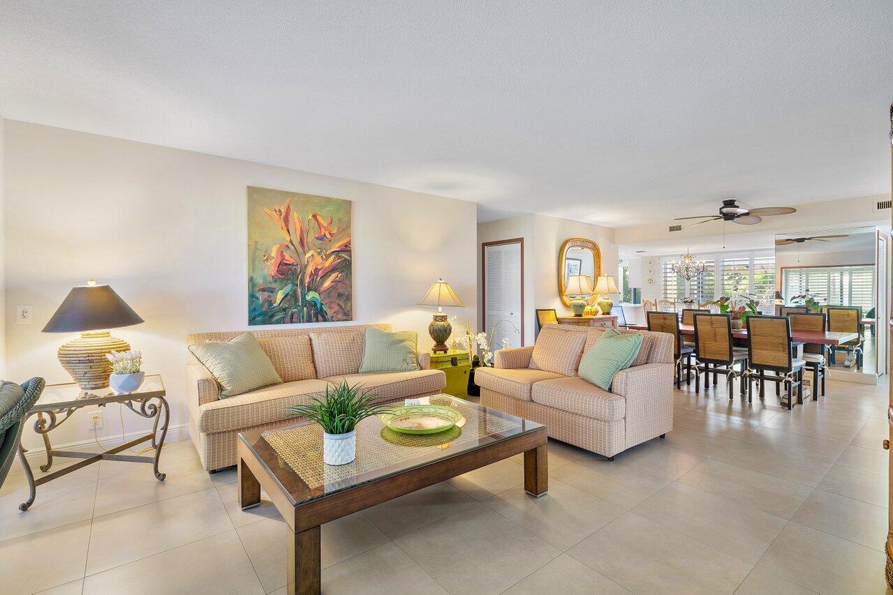 3677 Quail Ridge Drive, Unit BOBWHITE B Boynton Beach, FL 33436 - Photo 4 of 47 a living room with furniture and a large window