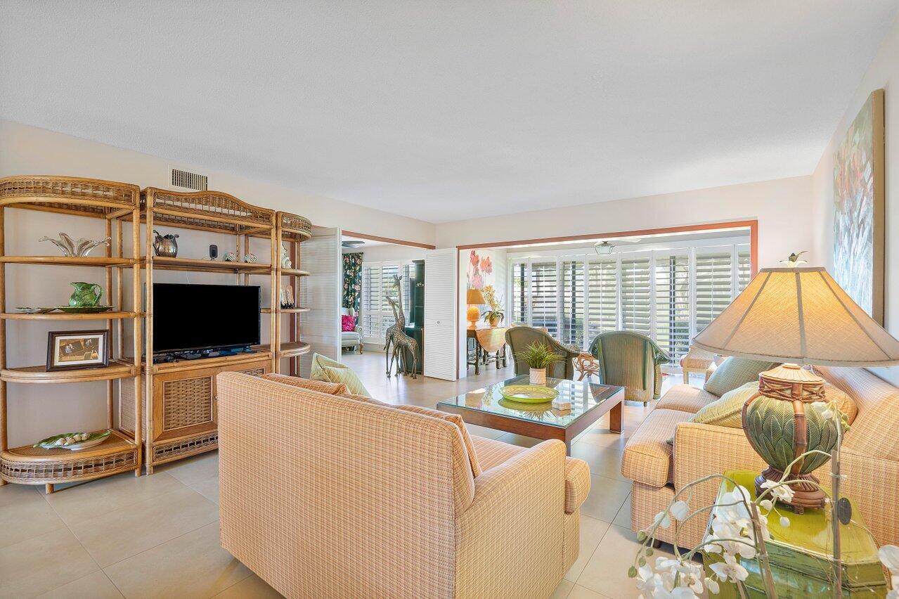 3677 Quail Ridge Drive, Unit BOBWHITE B Boynton Beach, FL 33436 - Photo 8 of 47 a living room with furniture and a flat screen tv
