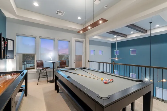 an aerial view of a house with outdoor space and sitting area