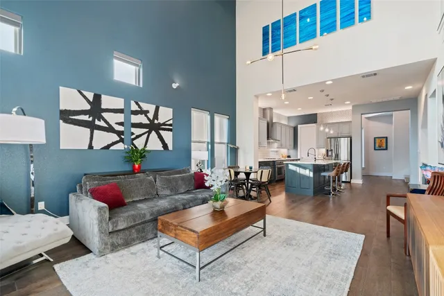 a spacious bathroom with a granite countertop sink a toilet a mirror and shower