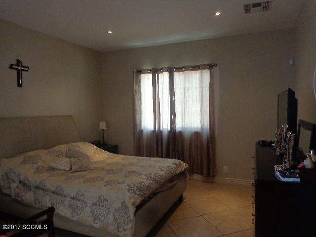 430 Churea Lane Rio Rico, AZ 85648 - Photo 7 of 14 a bedroom with a bed tv and a window