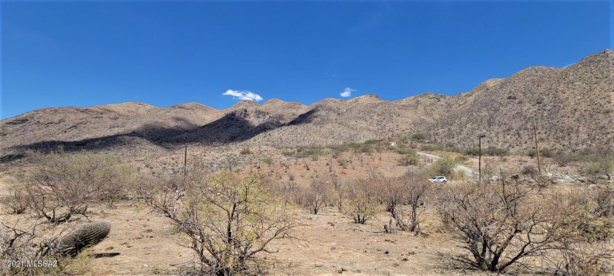 1508 Vía San Cayetano, Unit 6 Rio Rico, AZ 85648 - Photo 5 of 6 a view of a dry yard with mountains in the background