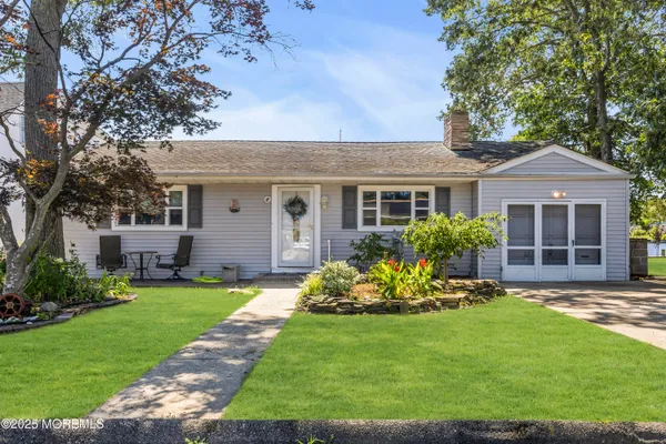 a front view of house with a garden and patio