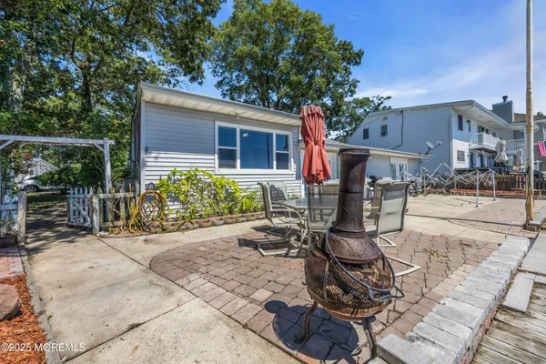 a view of a backyard with sitting area and garden