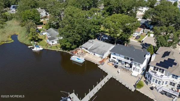 an aerial view of residential house with outdoor space and parking