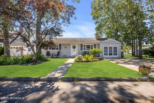 a front view of a house with a garden