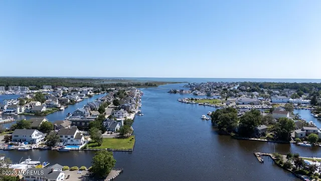 a kitchen with stainless steel appliances granite countertop a stove a sink dishwasher and a refrigerator