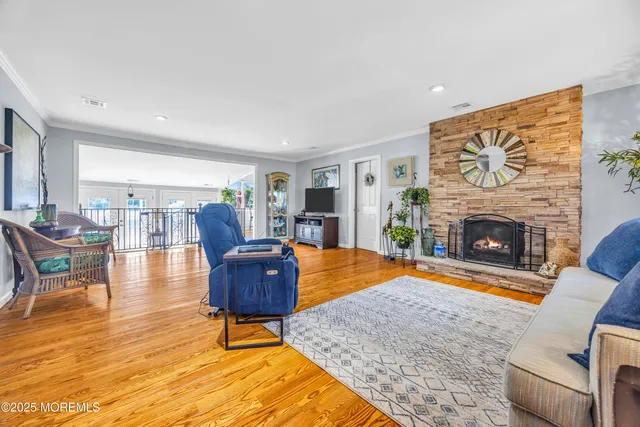 a kitchen with stainless steel appliances kitchen island granite countertop a stove a sink a dining table and chairs