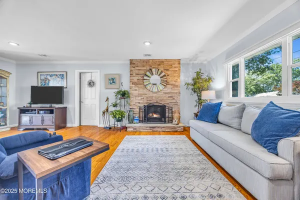a living room with furniture a flat screen tv and a fireplace