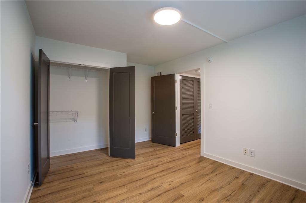 41 25th Street Northwest, Unit 5 Atlanta, GA 30309 - Photo 11 of 15 an empty room with wooden floor and closet