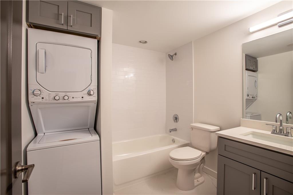 41 25th Street Northwest, Unit 5 Atlanta, GA 30309 - Photo 13 of 15 a white toilet sitting next to a bathroom sink