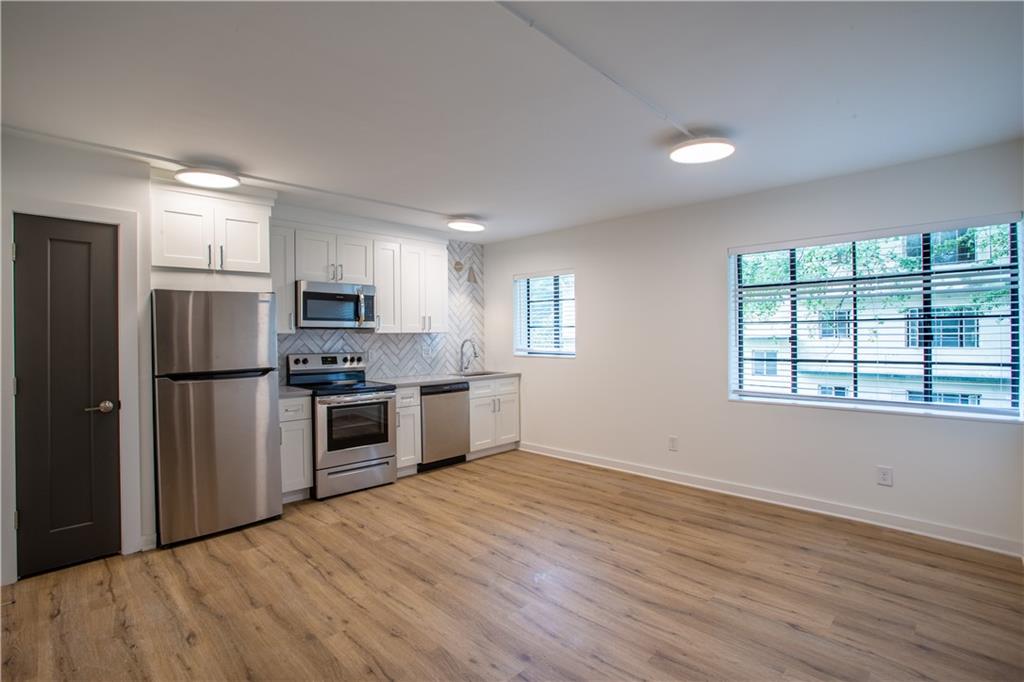 41 25th Street Northwest, Unit 5 Atlanta, GA 30309 - Photo 6 of 15 a kitchen with stainless steel appliances a refrigerator sink and stove