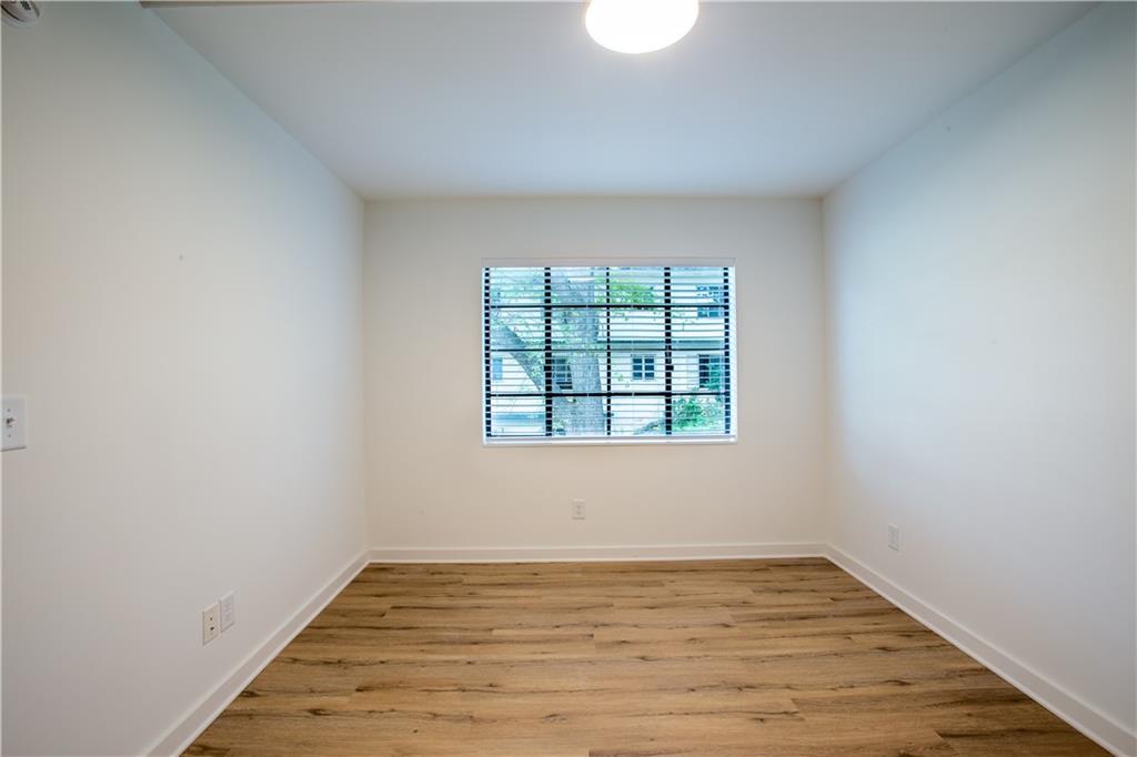 41 25th Street Northwest, Unit 5 Atlanta, GA 30309 - Photo 10 of 15 a view of an empty room with wooden floor and a window