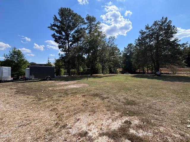 a view of a house with swimming pool and a yard