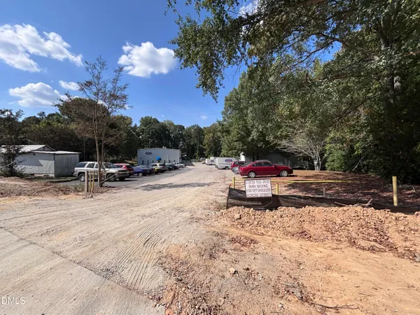 a view of a field of grass and trees