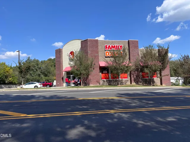 a front view of multi story residential apartment building with yard