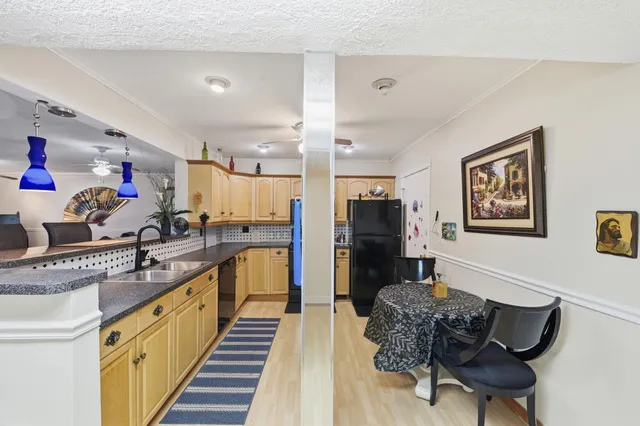 a kitchen with stainless steel appliances granite countertop a sink refrigerator and microwave