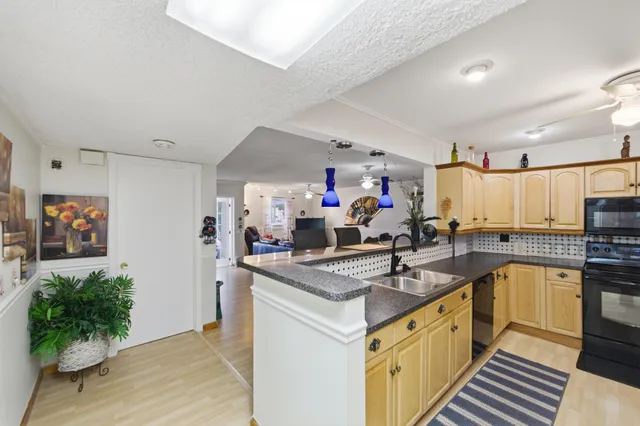 a kitchen with stainless steel appliances granite countertop a refrigerator and a stove