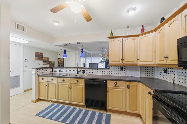 a very nice looking dining room with kitchen island white cabinets and stainless steel appliances