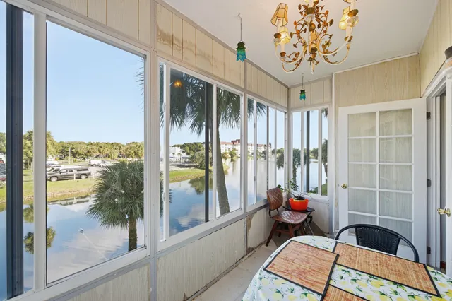 a bedroom with furniture and a large window