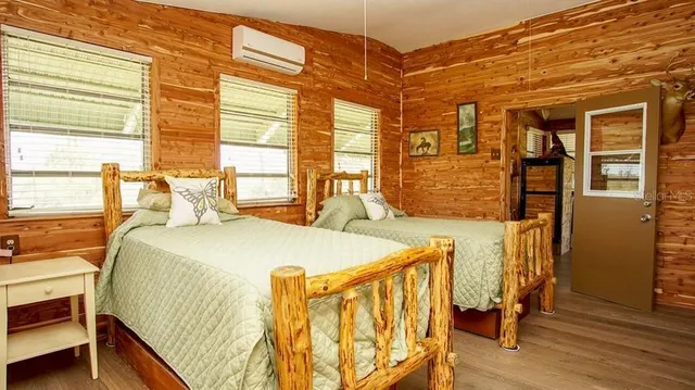 a bed sitting in a bedroom next to a window