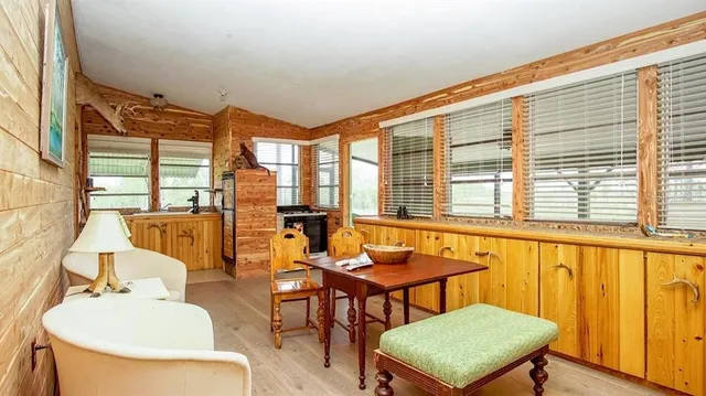 a dining room with furniture and a window