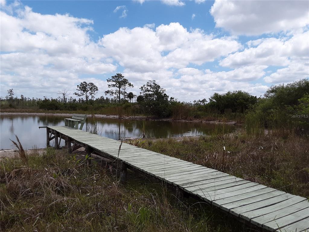 Xx Xx Romor Ranch Ochopee, FL 34141 - Photo 7 of 8 a view of a lake with houses in the background