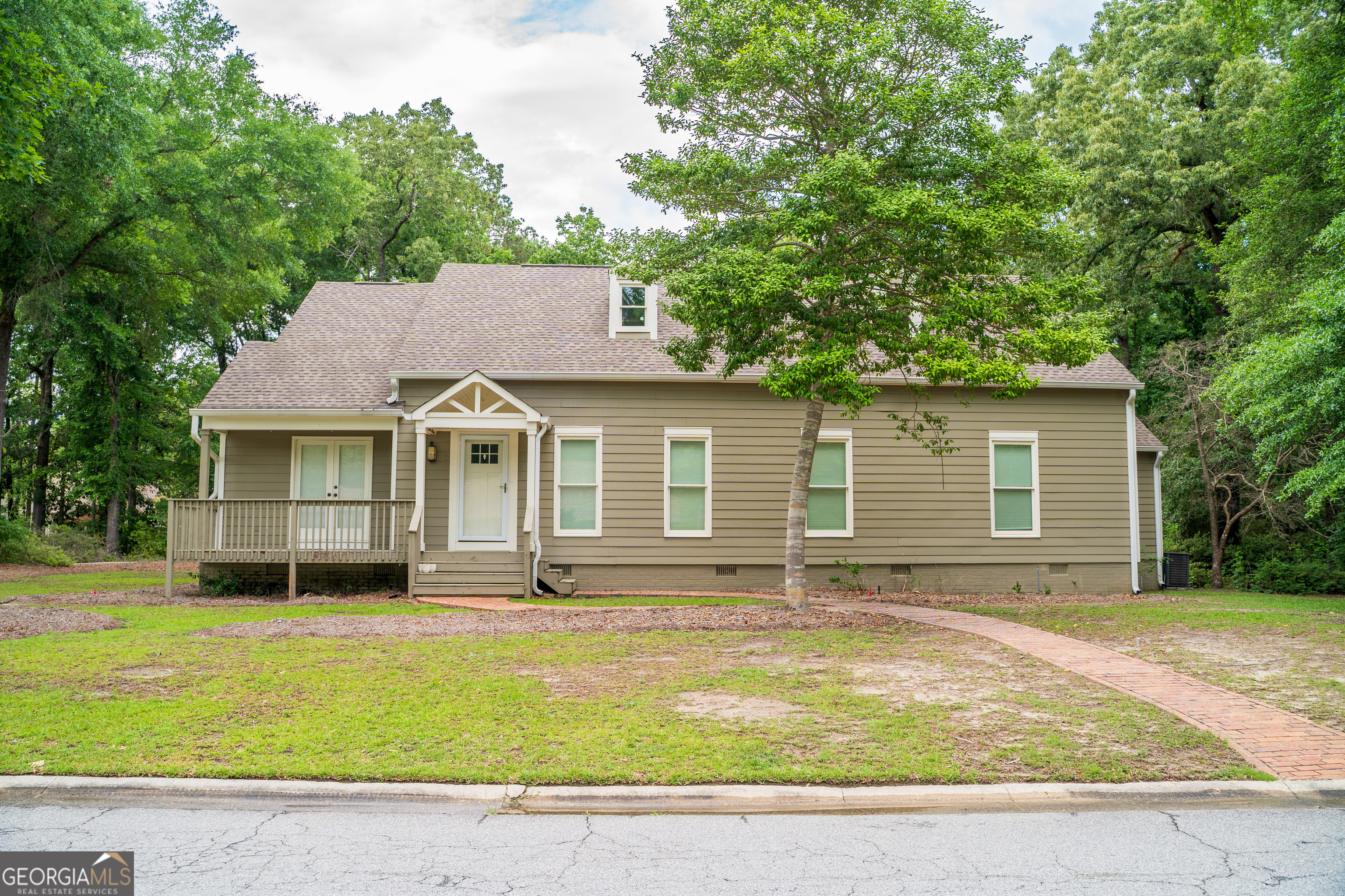 a view of a house with a backyard and a tree