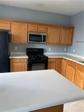 a kitchen with stainless steel appliances a refrigerator sink and cabinets