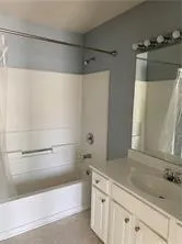 a bathroom with a bathtub and a sink