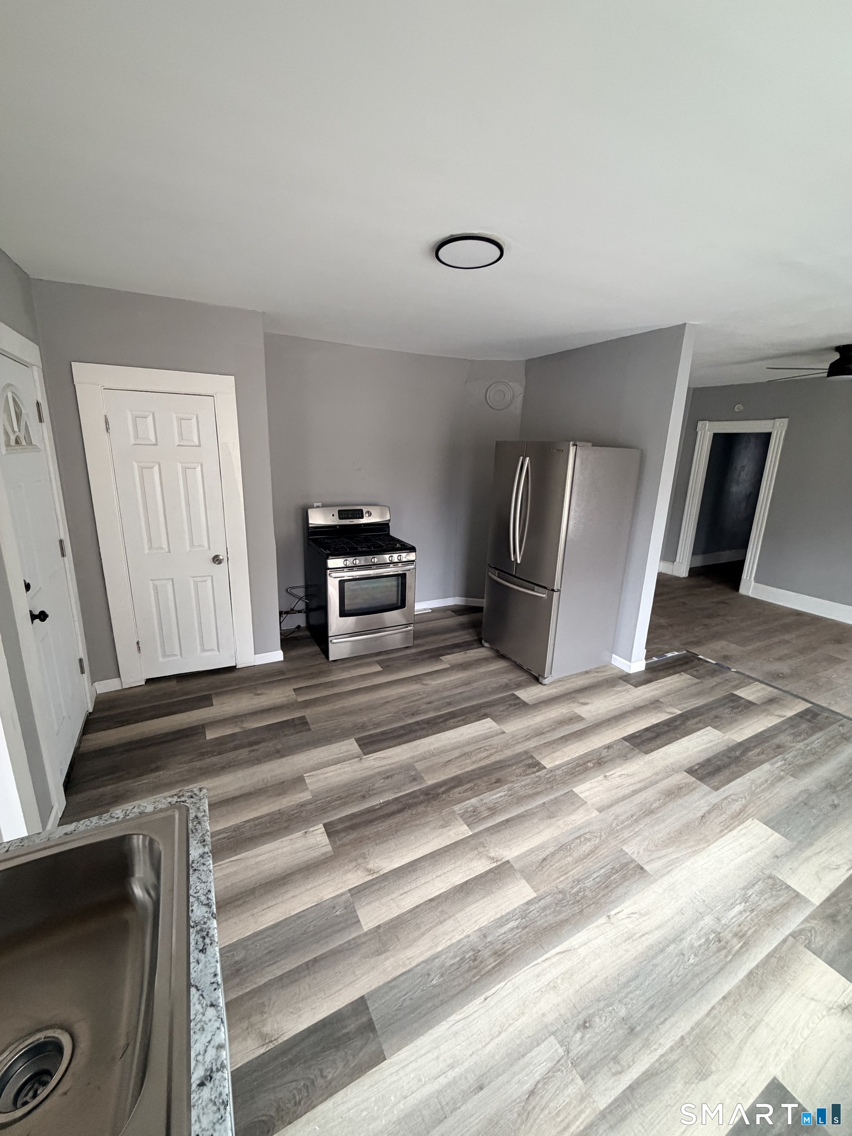 89 Birch Street Manchester, CT 06040 - Photo 13 of 14 a view of kitchen with cabinets and wooden floor