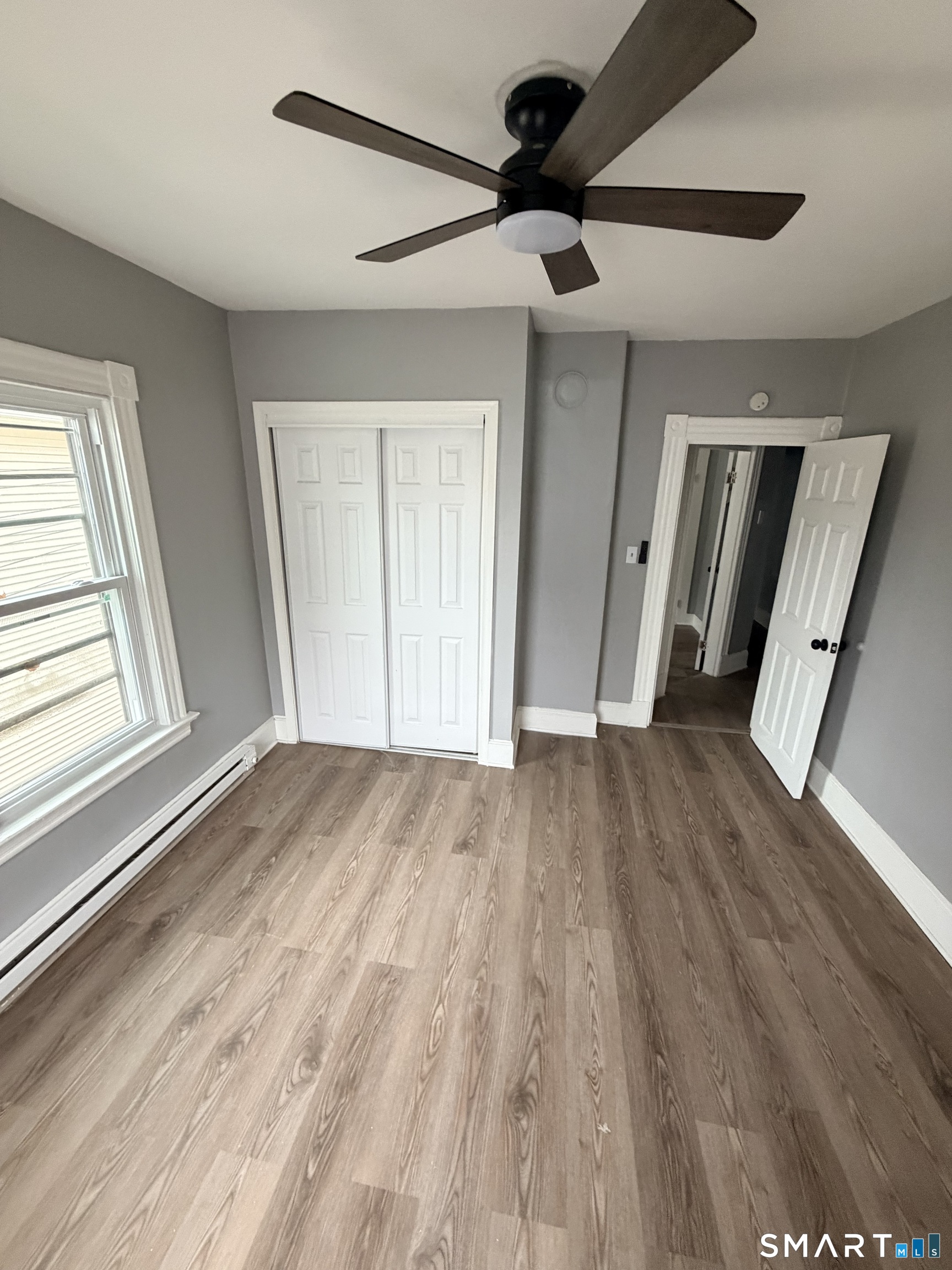 89 Birch Street Manchester, CT 06040 - Photo 2 of 14 a view of empty room with wooden floor and fan