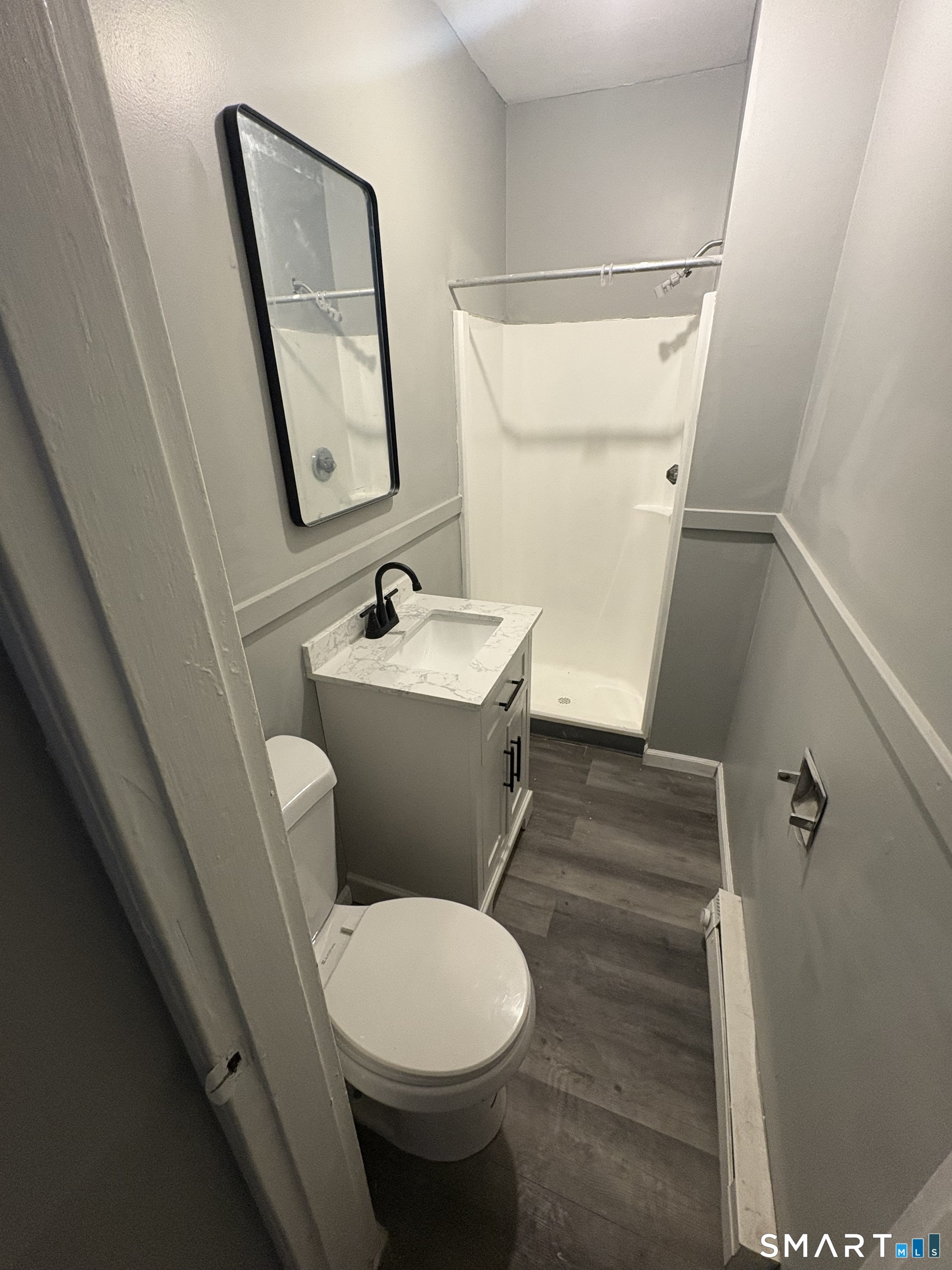 89 Birch Street Manchester, CT 06040 - Photo 3 of 5 a bathroom with a sink toilet and mirror