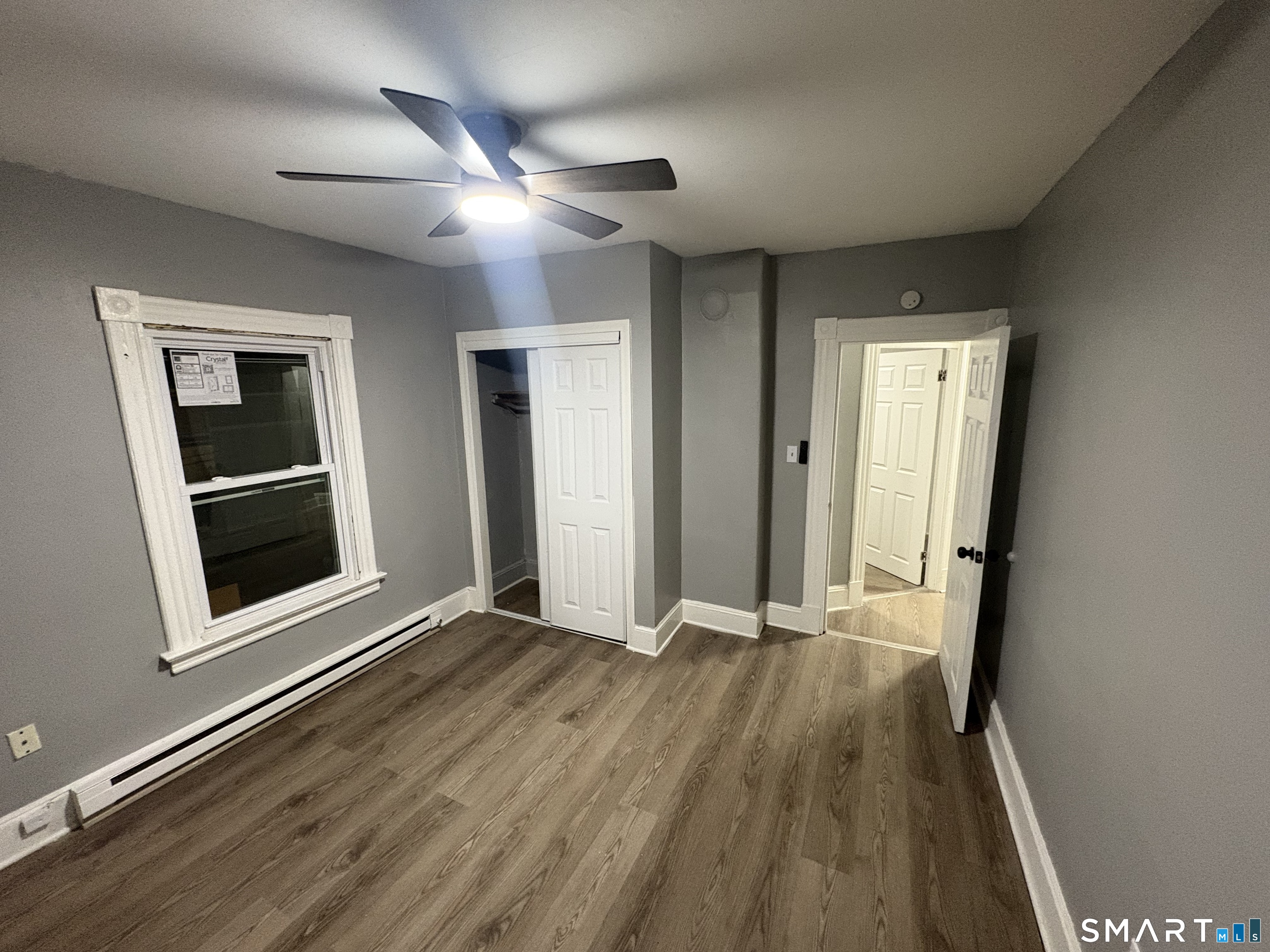 89 Birch Street Manchester, CT 06040 - Photo 4 of 5 a view of an empty room with wooden floor and a window