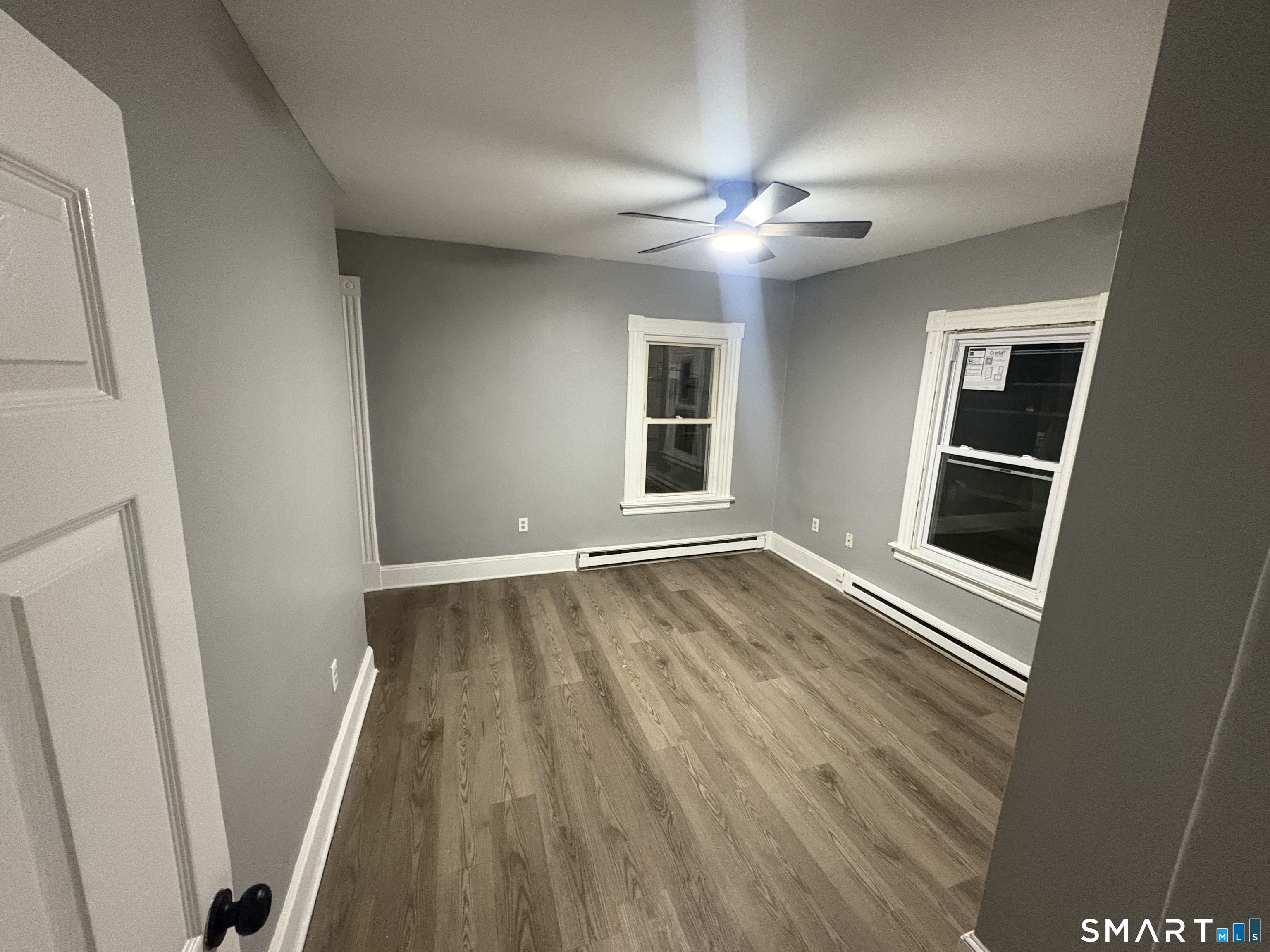 89 Birch Street Manchester, CT 06040 - Photo 5 of 5 a view of an empty room with wooden floor and a window