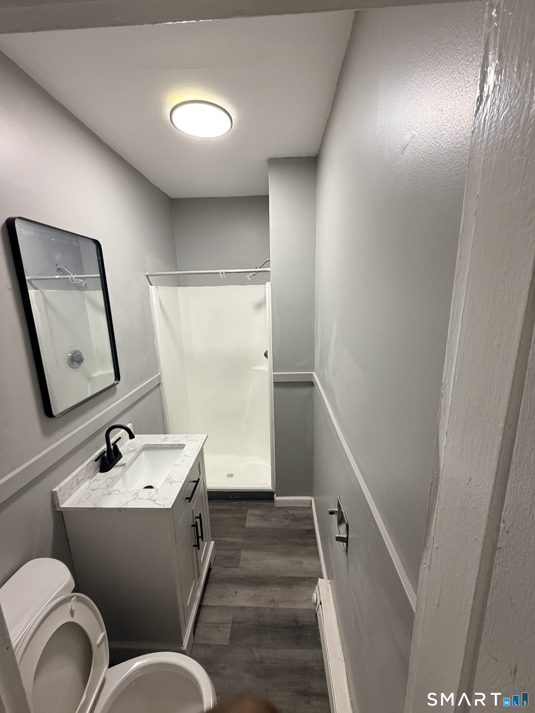 89 Birch Street Manchester, CT 06040 - Photo 10 of 14 a bathroom with a toilet sink and mirror