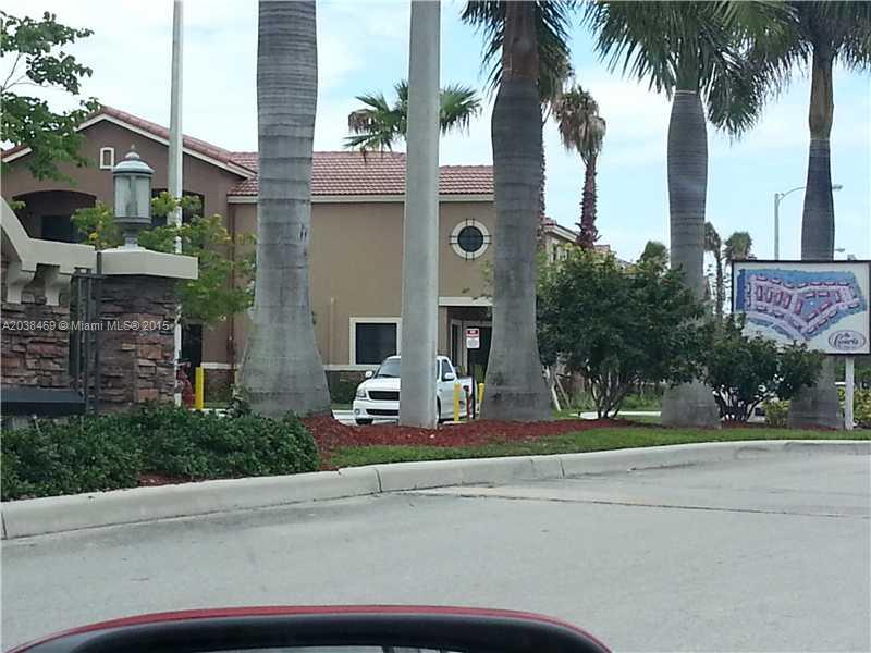 22501 Southwest 88th Place, Unit 1525 Cutler Bay, FL 33190 - Photo 3 of 8 a front view of multiple houses with yard