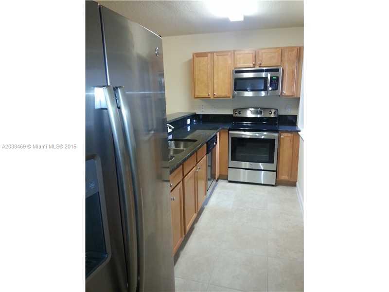 22501 Southwest 88th Place, Unit 1525 Cutler Bay, FL 33190 - Photo 4 of 8 a kitchen with stainless steel appliances a refrigerator and a stove