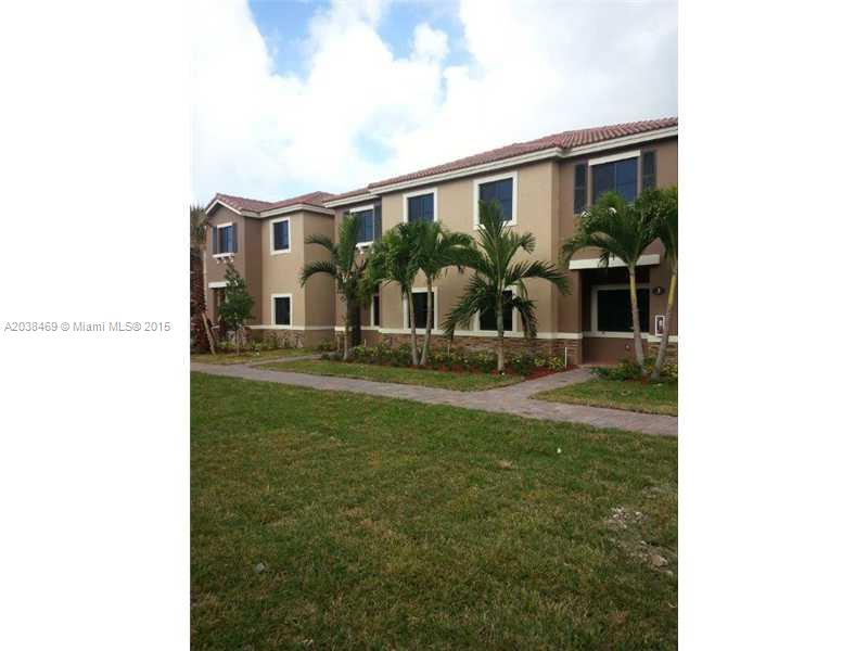22501 Southwest 88th Place, Unit 1525 Cutler Bay, FL 33190 - Photo 8 of 8 a front view of a house with garden