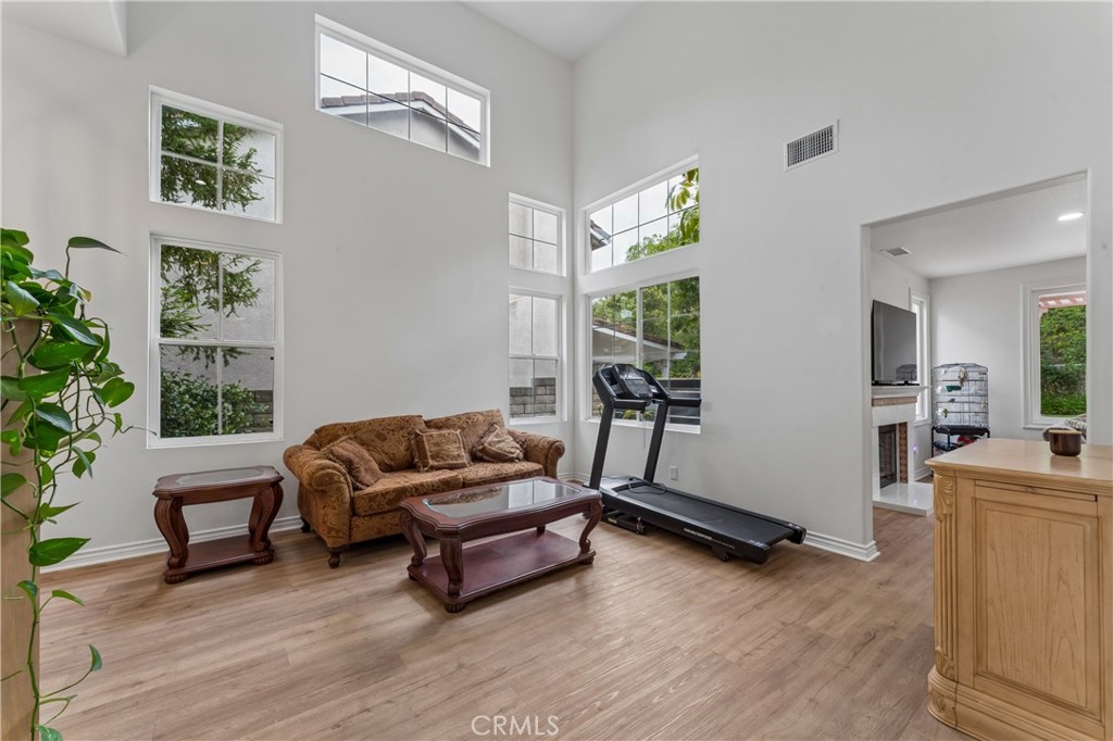 26023 Salinger Lane Stevenson Ranch, CA 91381 - Photo 4 of 35 Spacious living room featuring impressive high ceilings, abundant natural light, and a modern open-concept layout.