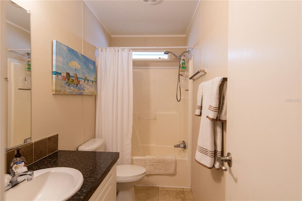 3 Edam Street Punta Gorda, FL 33950 - Photo 11 of 22 a bathroom with a granite countertop sink toilet a mirror and shower