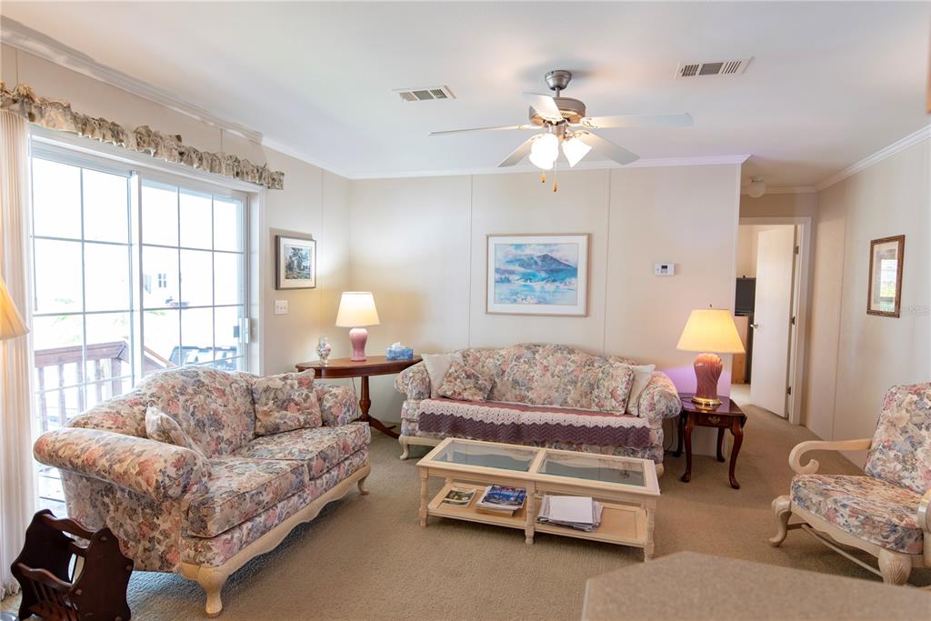3 Edam Street Punta Gorda, FL 33950 - Photo 6 of 22 a living room with furniture a chandelier and a window