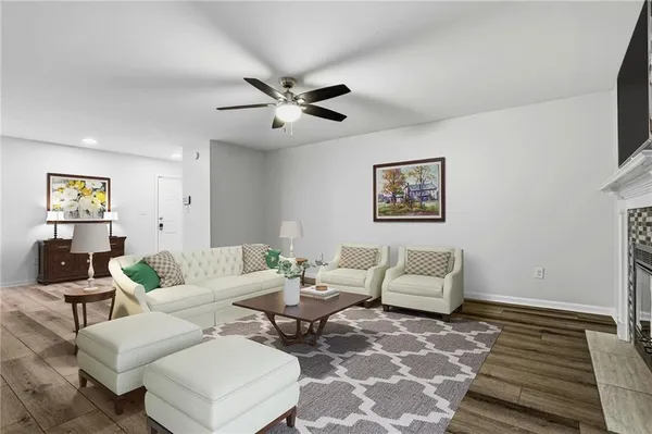 a living room with furniture and wooden floor