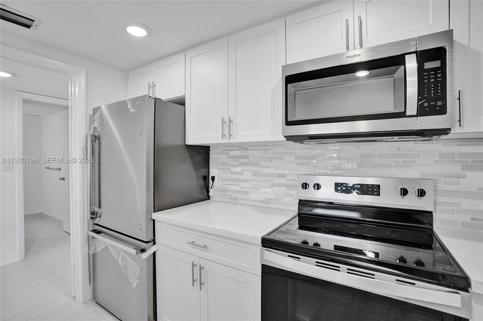 4164 Inverrary Drive, Unit 305 Lauderhill, FL 33319 - Photo 13 of 32 a kitchen with appliances and cabinets