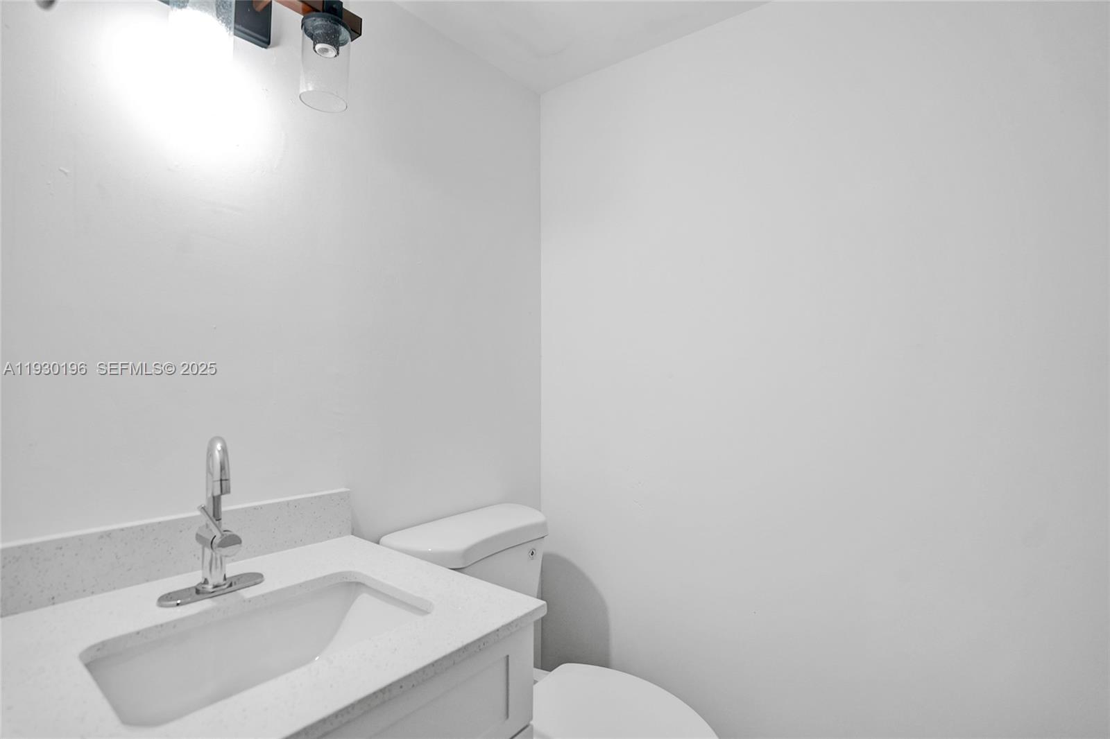 4164 Inverrary Drive, Unit 305 Lauderhill, FL 33319 - Photo 21 of 32 a bathroom with a sink toilet and mirror