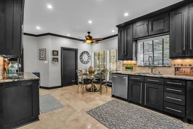 a kitchen with stainless steel appliances kitchen island granite countertop a refrigerator and a sink