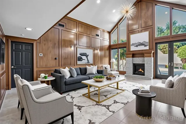 a dining room with wooden floor a chandelier a wooden table and chairs
