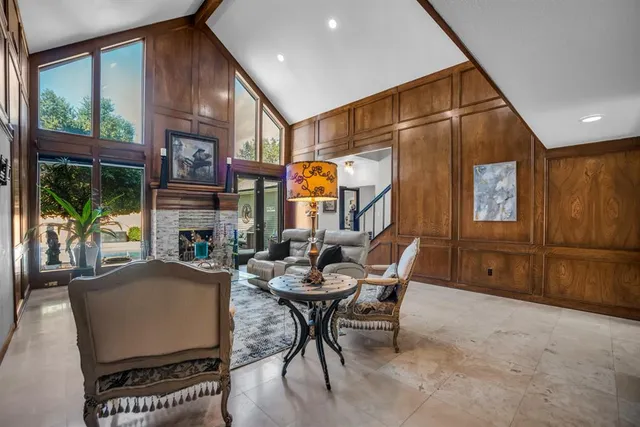a dining room with furniture and a large window
