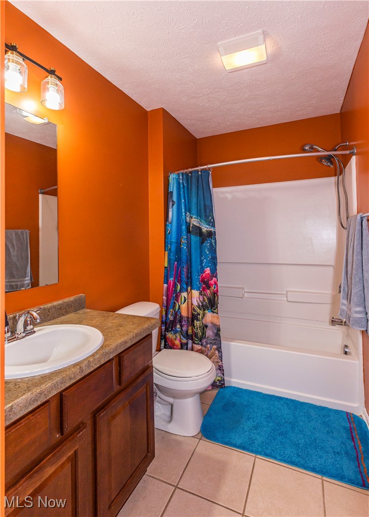 16727 Galehouse Road Doylestown, OH 44230 - Photo 21 of 38 Full bathroom with shower / bath combo with shower curtain, a textured ceiling, vanity, and toilet